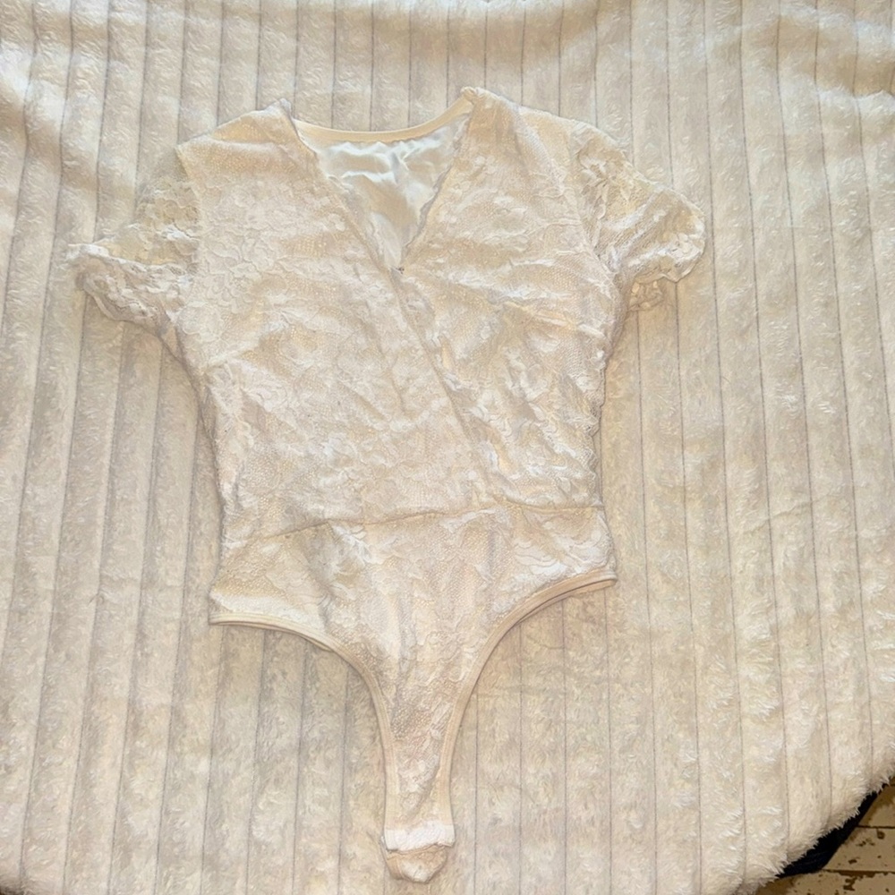Pure white one piece outside is lace but inside is very nice and silky!!